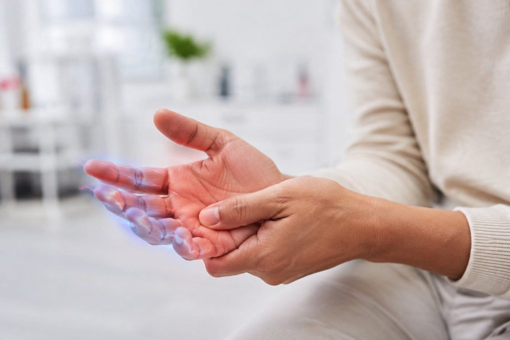 Person experiencing numbness and tingling in the hand